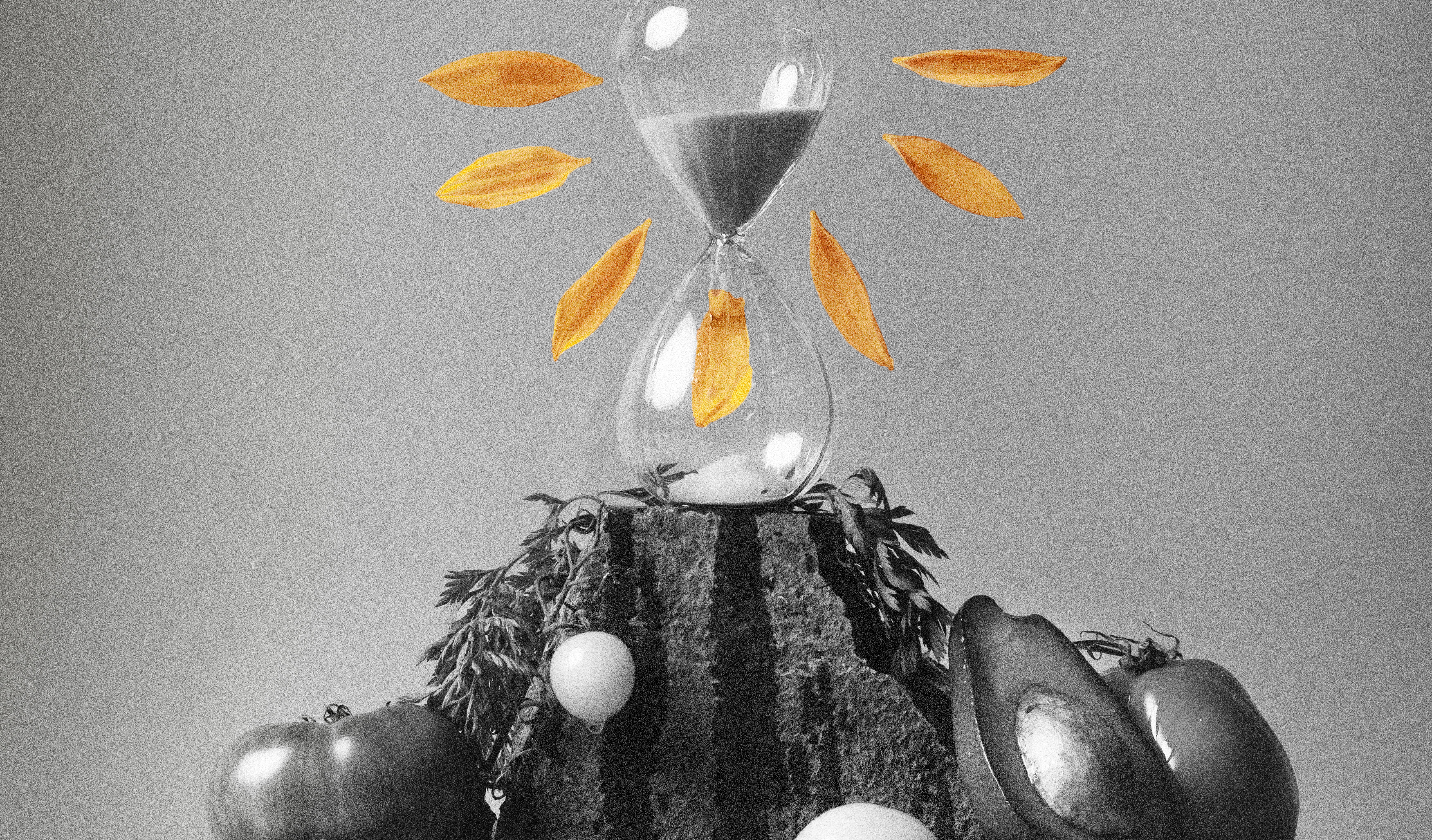 Hour glass surrounded by petals with tomatoes and avocado